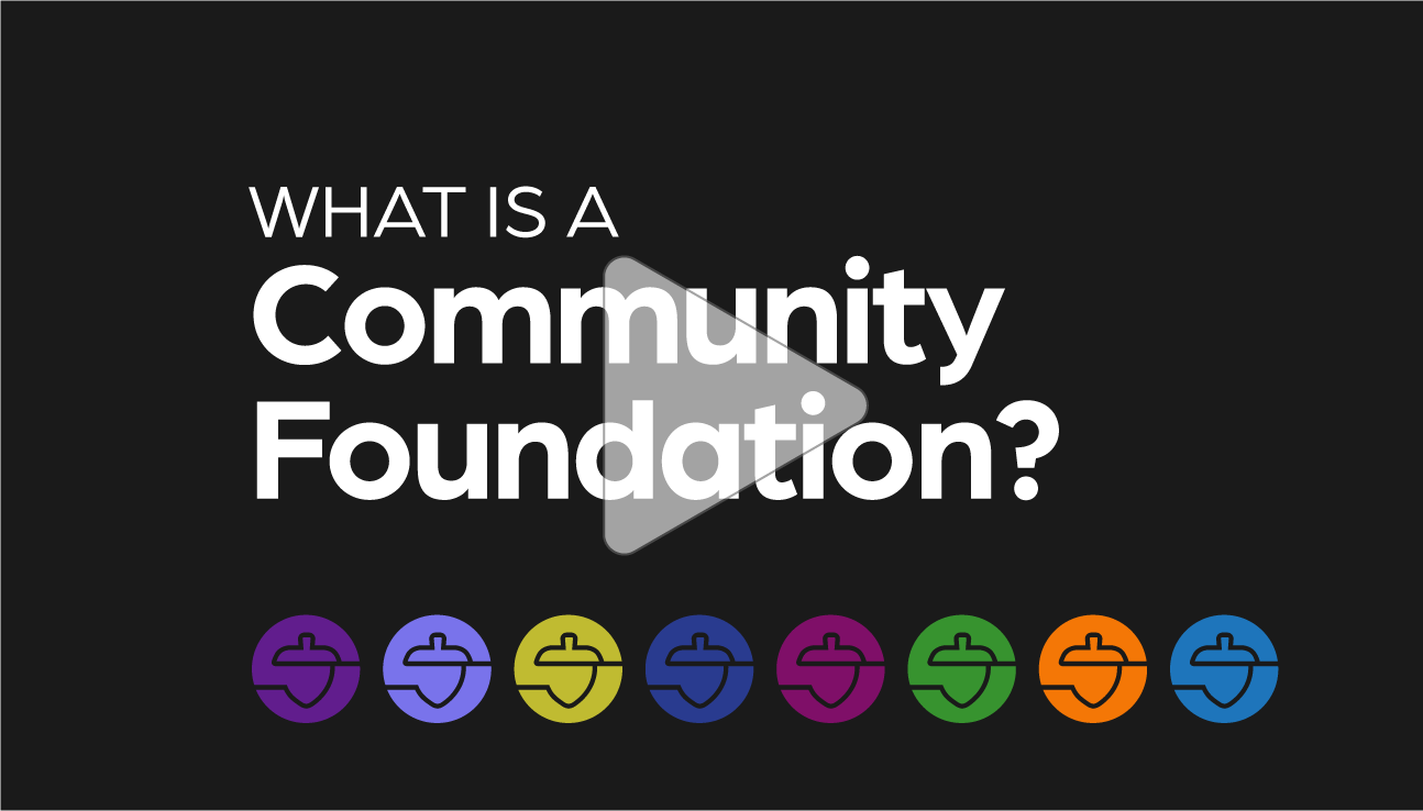 Text on a black background reads What is a Community Foundation? with a play button overlay. Colorful icons in purple, blue, teal, green, yellow, pink, orange, and dark blue are lined up along the bottom.
